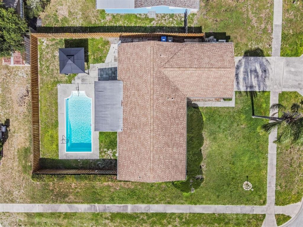 An aerial view shows a house with a swimming pool, patio, and fenced backyard — 11440 130TH AVENUE, LARGO, FL