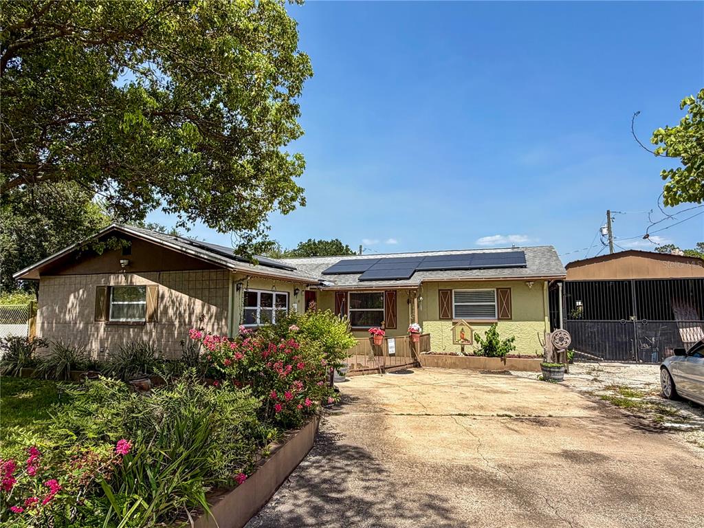 A single-story house with solar panels on the roof and a concrete driveway — 45 CASWELL DRIVE, ORLANDO, FL
