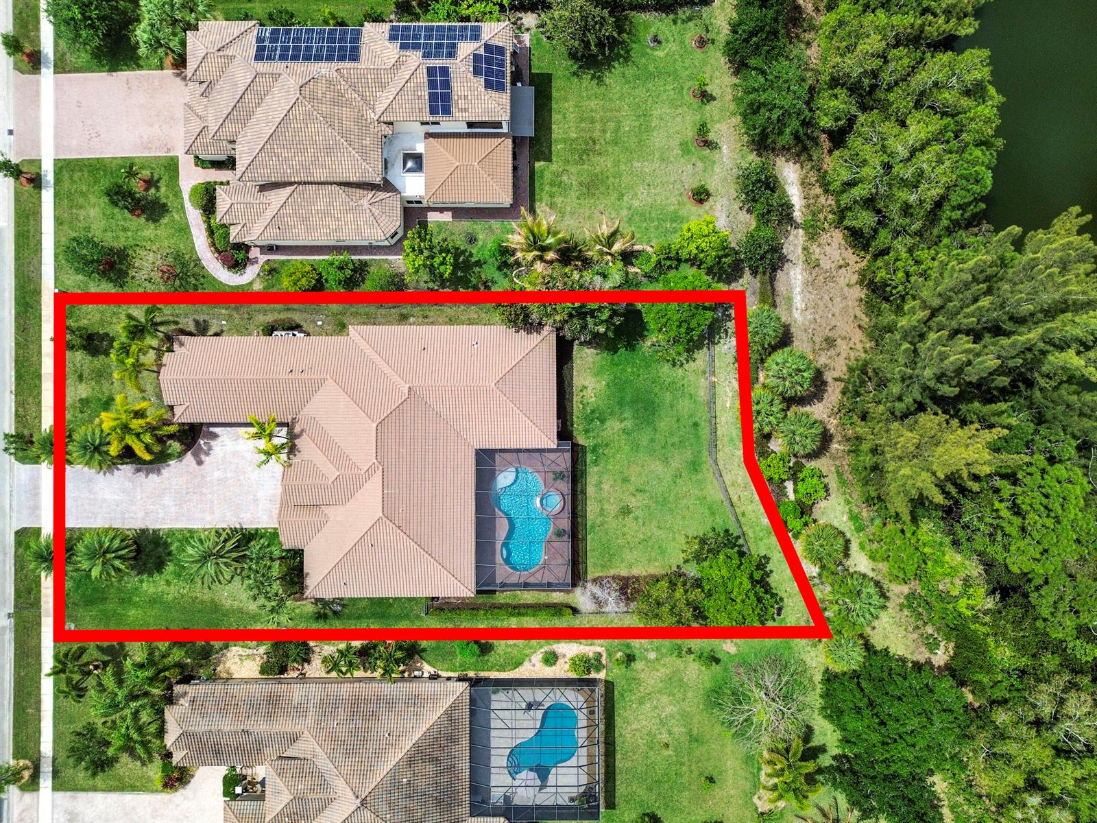 Aerial view of a residential property with a tiled roof, swimming pool, and landscaped yard — 7777 Eden Ridge Way, West Palm Beach FL 33412, WEST PALM BEACH, FL