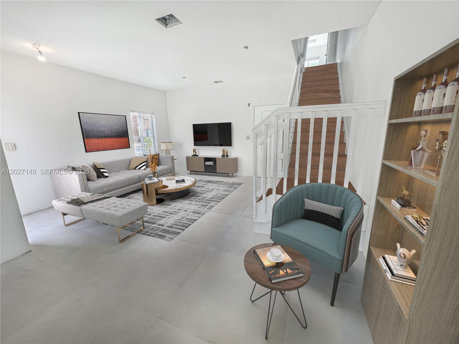This living room features a grey sofa, a teal armchair, and a wooden staircase — 10754 NW 85th Ter # 34, Doral FL 33178, DORAL, FL