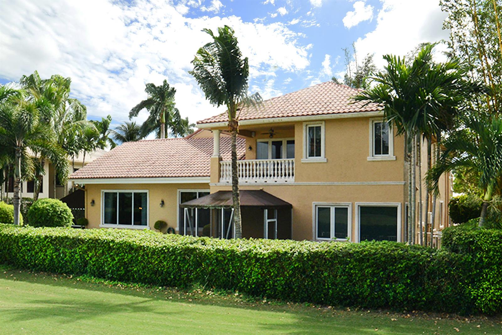 A two-story tan stucco house with a tiled roof and a manicured hedge exterior — 7355 Mandarin Drive, Boca Raton FL 33433, BOCA RATON, FL