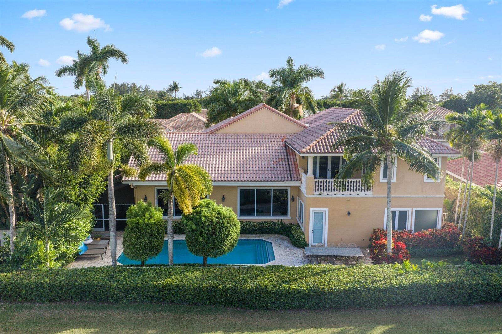 An aerial view of a two-story house with a swimming pool and palm trees — 7355 Mandarin Drive, Boca Raton FL 33433, BOCA RATON, FL