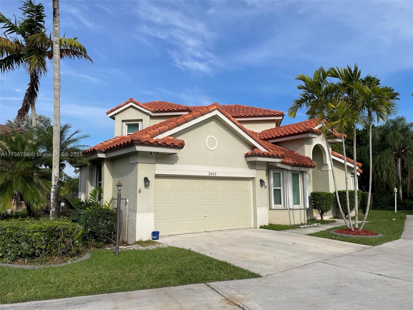 A living room with high ceilings, tile floors, and a sectional sofa faces a pool — 2602 Augusta Dr, Homestead FL 33035, HOMESTEAD, FL