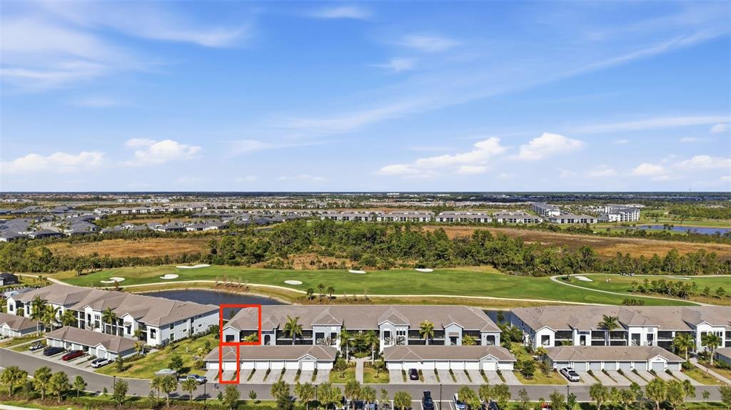 An aerial view shows a multi-unit residential building with a red outline highlighting a section — 12440 WELLEN GOLF STREET UNIT 201, VENICE, FL