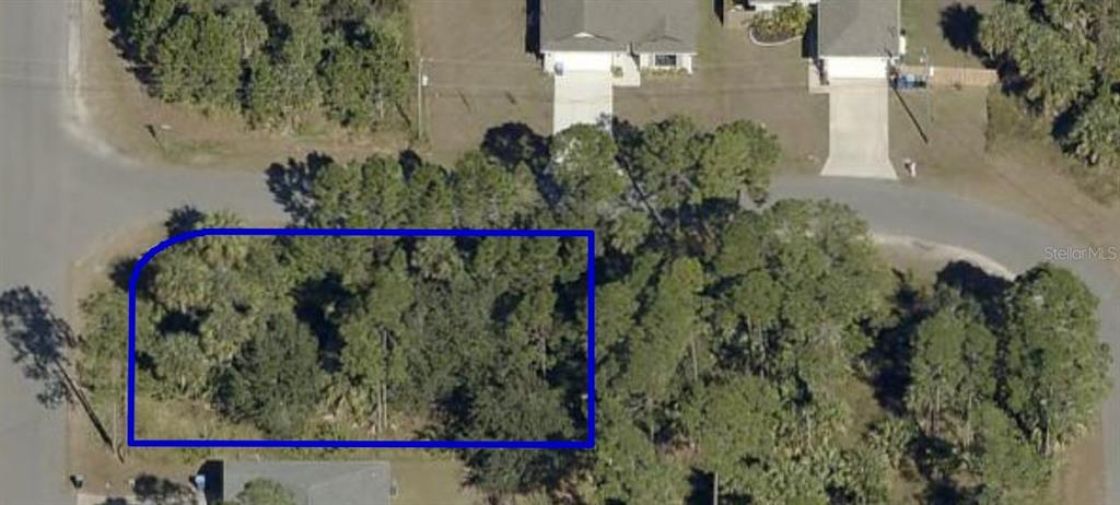An aerial view shows a vacant, wooded residential lot outlined in blue — 2900 FISKE ROAD SE, PALM BAY, FL