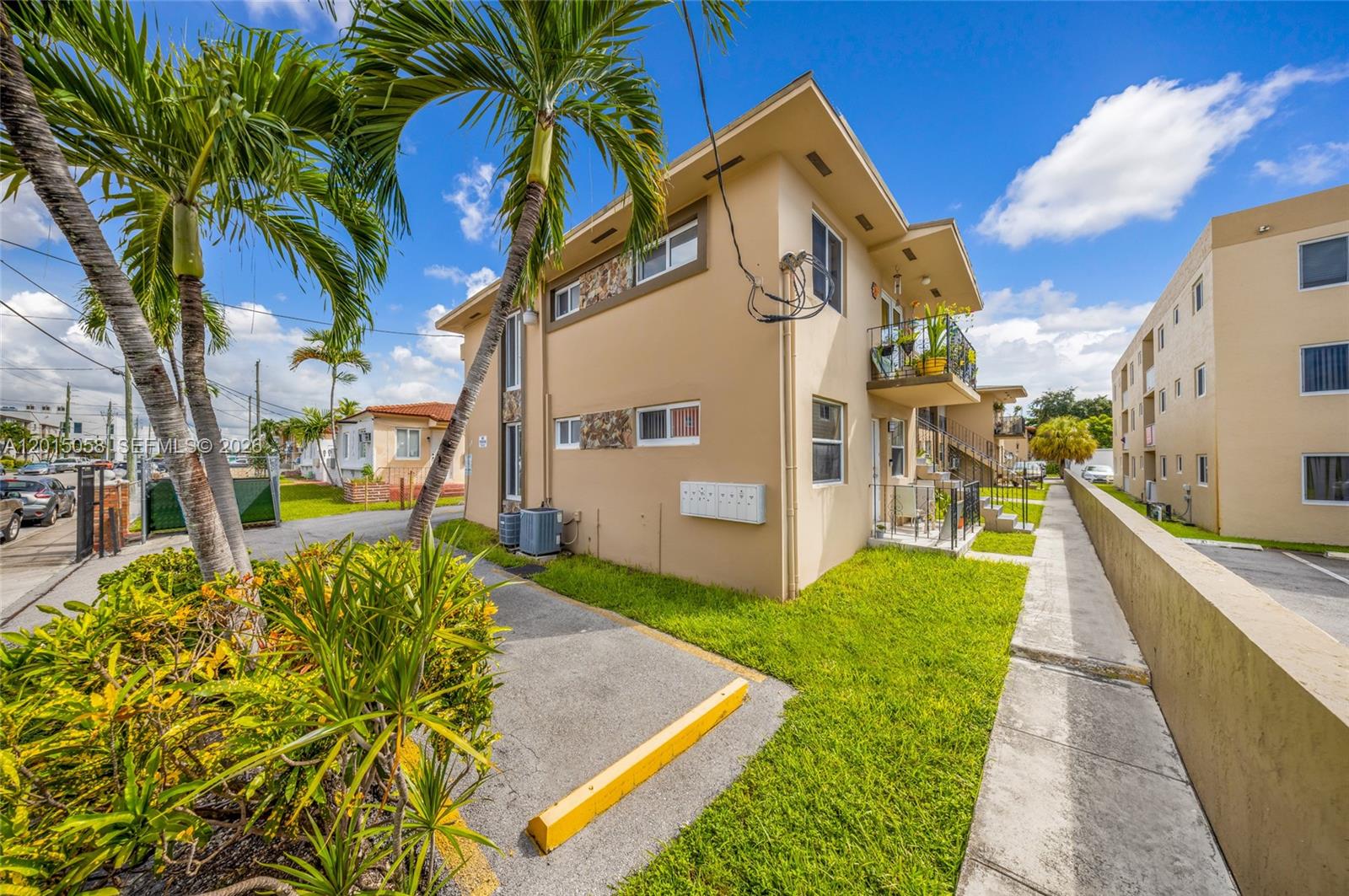 A two-story tan apartment building features a small balcony and a paved parking area — 225 SW 18th Ave, Miami FL 33135, MIAMI, FL