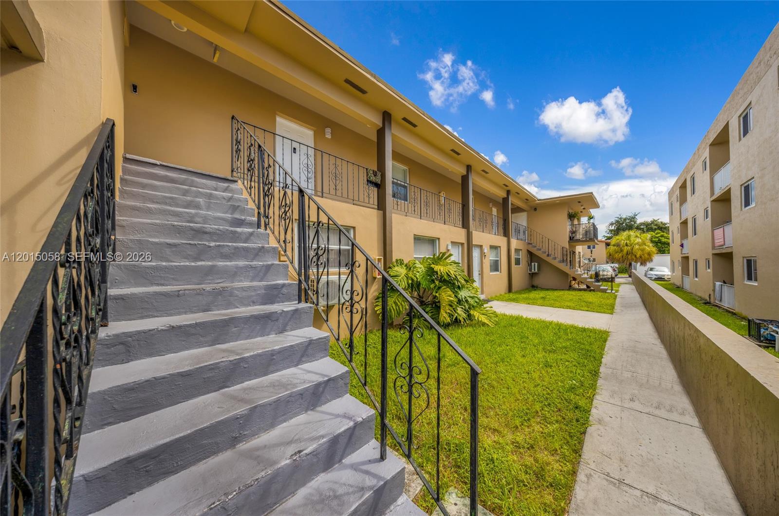 An exterior view shows a multi-story apartment building with concrete stairs and metal railings — 225 SW 18th Ave, Miami FL 33135, MIAMI, FL