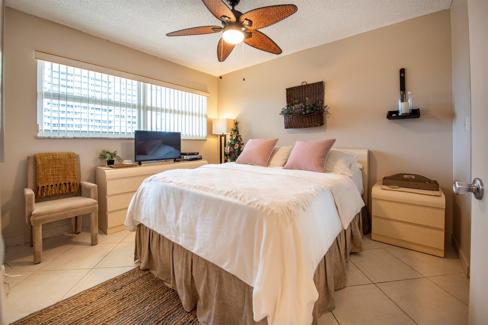 A bedroom features a bed with white bedding, a ceiling fan, and a window with blinds — 1391 S Ocean Boulevard # 308, Pompano Beach FL 33062, POMPANO BEACH, FL