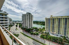 An elevated view shows a street, palm trees, a canal, and several high-rise apartment buildings — 5555 Collins Ave # 15W, Miami Beach FL 33140, MIAMI BEACH, FL