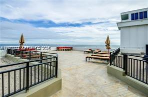 A spacious outdoor terrace features lounge chairs, umbrellas, and a railing overlooking the ocean — 5555 Collins Ave # 15W, Miami Beach FL 33140, MIAMI BEACH, FL