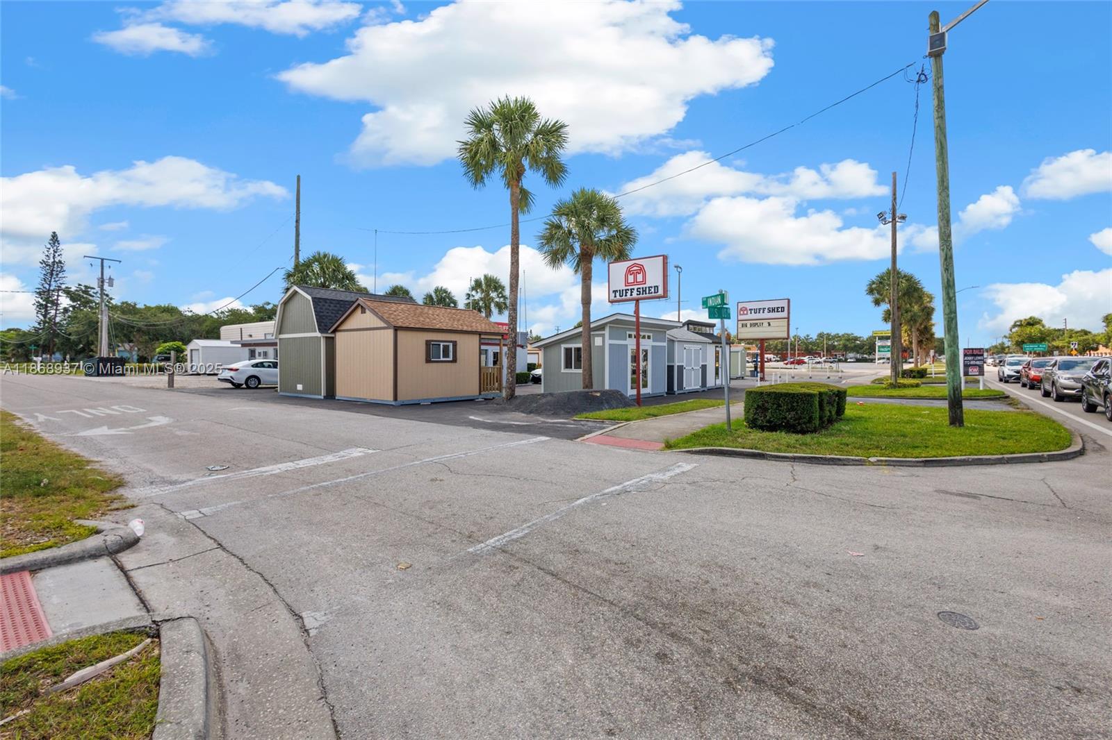 A Tuff Shed display lot features several small storage buildings and palm trees outdoors — 2402 S US HWY 1, Fort Pierce FL 34982, FORT PIERCE, FL