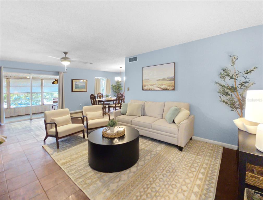 A living room features a beige sofa, two armchairs, a round coffee table, and dining area — 553 FAIRWAYS CIRCLE UNIT B, OCALA, FL
