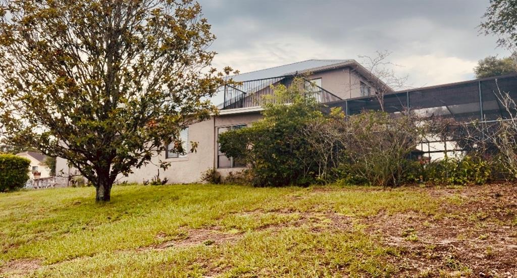A two-story house with a screened-in pool enclosure and a second-story balcony — 3145 PELL MELL DRIVE, ORLANDO, FL