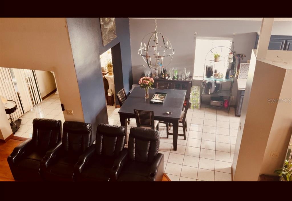 An elevated view of a dining area with a square table and black leather chairs — 3145 PELL MELL DRIVE, ORLANDO, FL