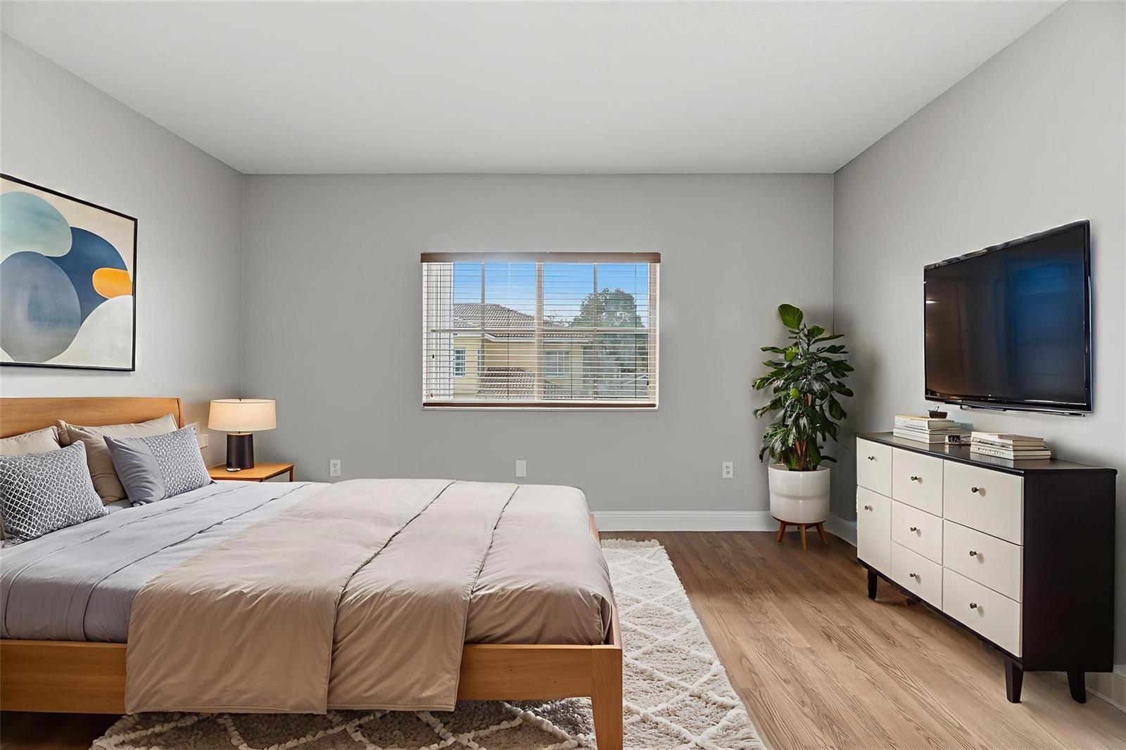 A bedroom features a wooden bed, a dresser with a television, and a window view — 2332 SW 126th Avenue, Miramar FL 33027, MIRAMAR, FL