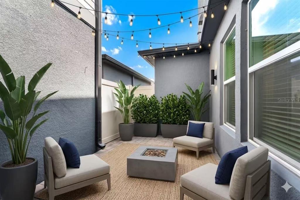 A small outdoor patio features a fire pit, four chairs, and string lights overhead — 7381 ALPINE BUTTERFLY LANE, ORLANDO, FL