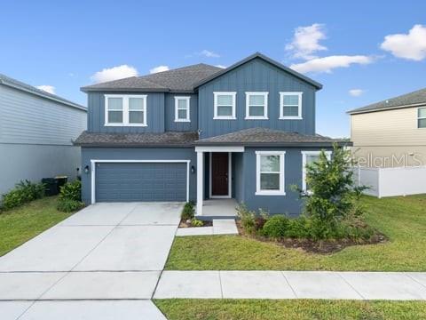 A two-story blue house with a two-car garage and a concrete driveway — 2099 DERWENT DRIVE, DAVENPORT, FL