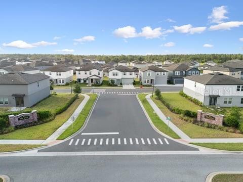 An aerial view shows a suburban neighborhood street with houses and a crosswalk — 2099 DERWENT DRIVE, DAVENPORT, FL