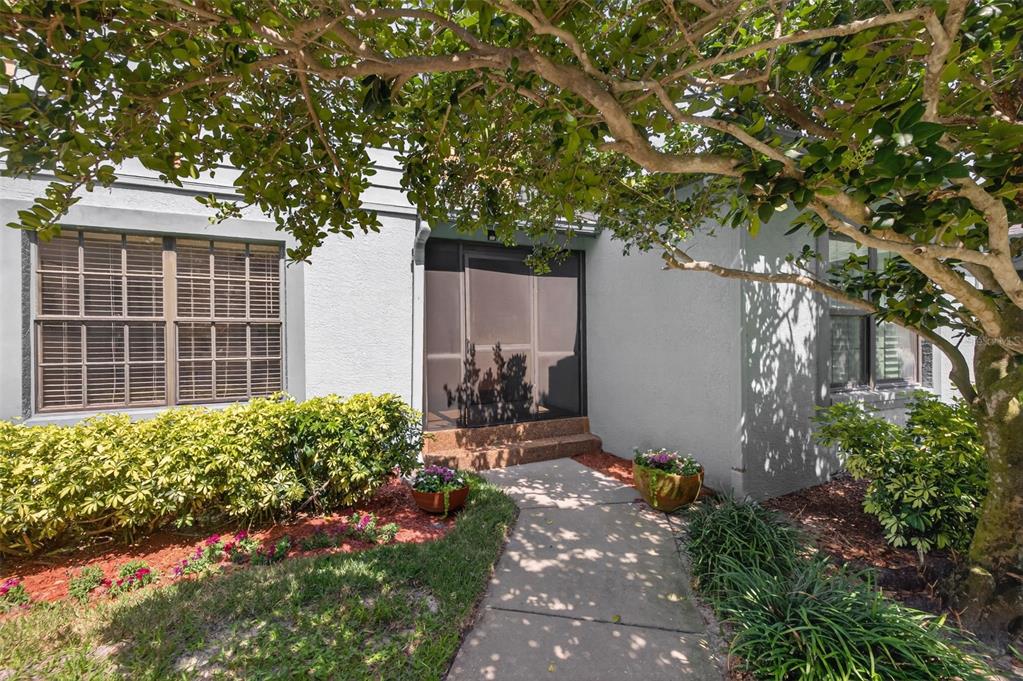 An aerial view shows a townhome with a fenced backyard and a driveway — 713 CAYA COSTA COURT NE, ST PETERSBURG, FL