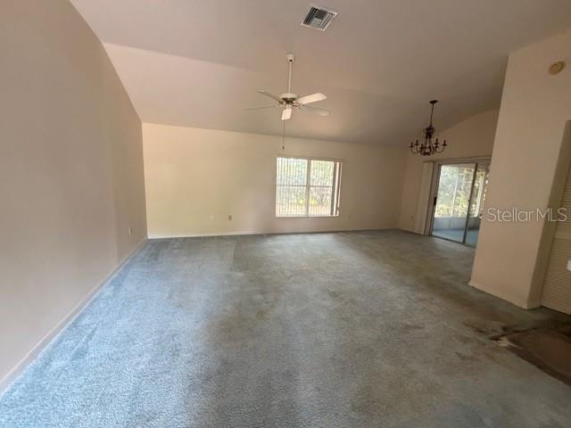 An empty living room with light-colored carpet, a vaulted ceiling, and a ceiling fan — 4268 N MAE WEST WAY, BEVERLY HILLS, FL