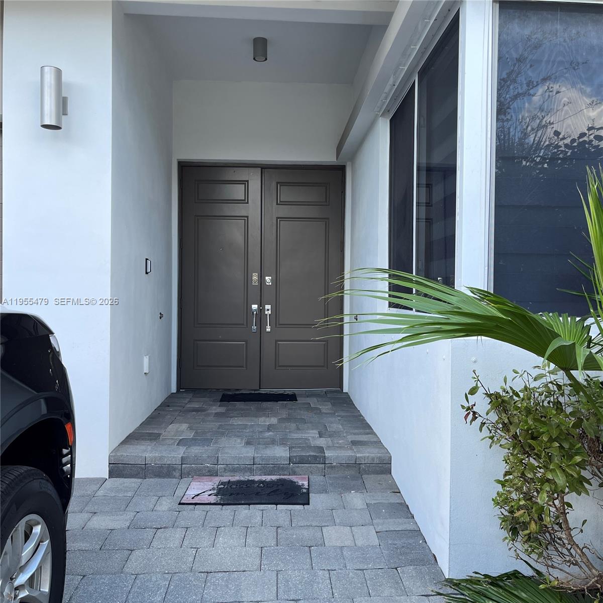 A paved walkway leads to a dark brown double front door under a covered entryway — 15062 SW 177th Ter, Miami FL 33187, MIAMI, FL