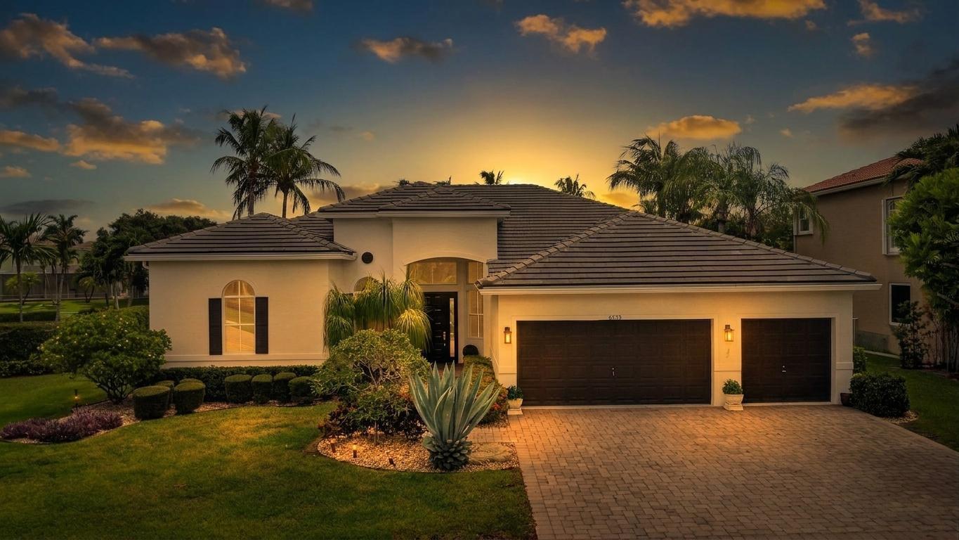 A single-story house with a dark tiled roof, white stucco walls, and a paved driveway — 6733 Finamore Circle, Lake Worth FL 33467, LAKE WORTH, FL