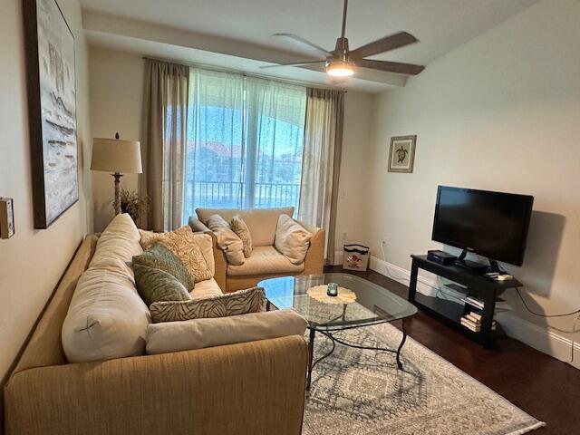 A living room features a beige sofa, glass coffee table, television, and a ceiling fan — 822 Villa Circle, Boynton Beach FL 33435, BOYNTON BEACH, FL