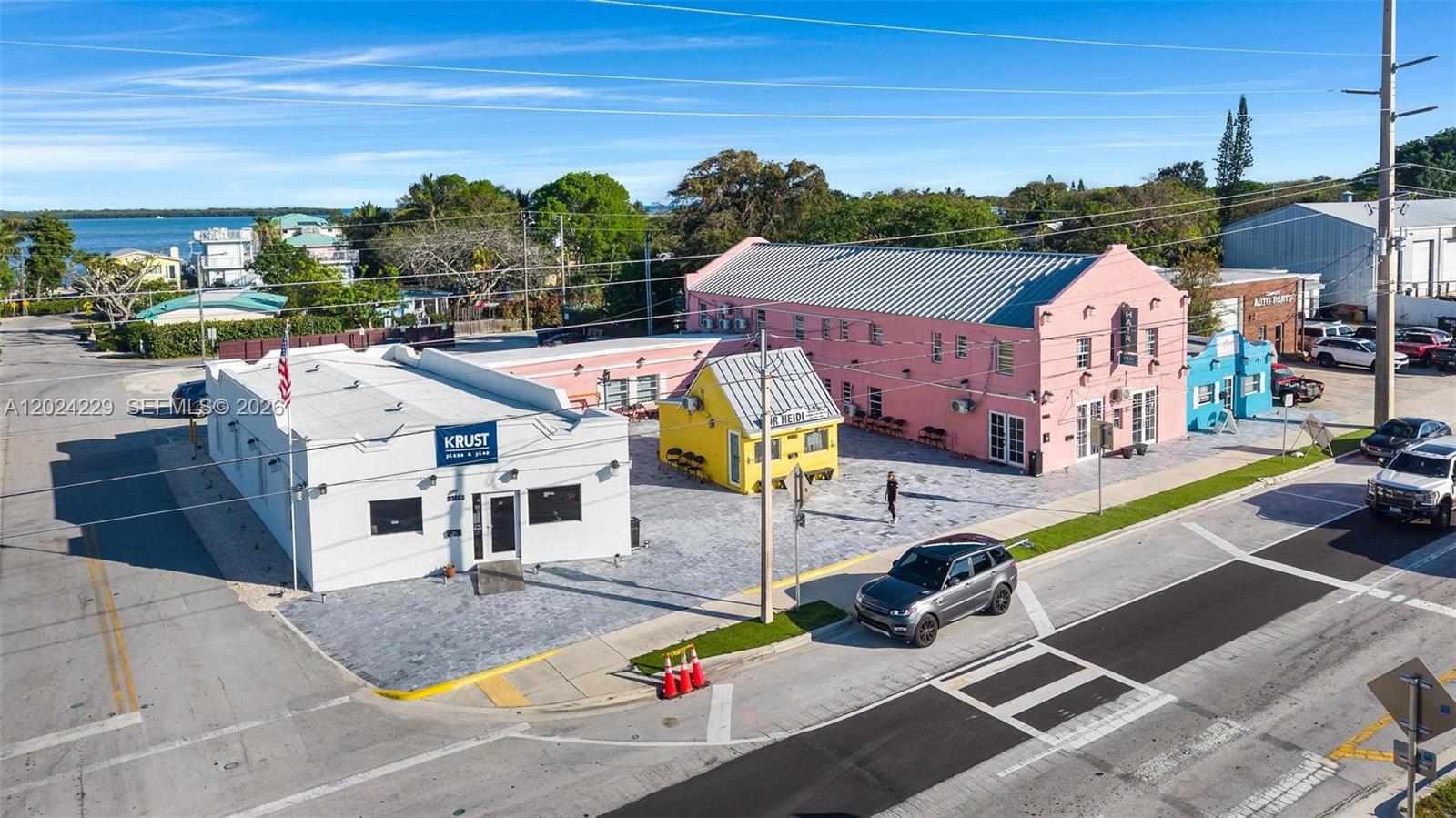 An aerial view shows a white building, a small yellow structure, and a pink building — 91865 Overseas Hwy, FL 33070, FL