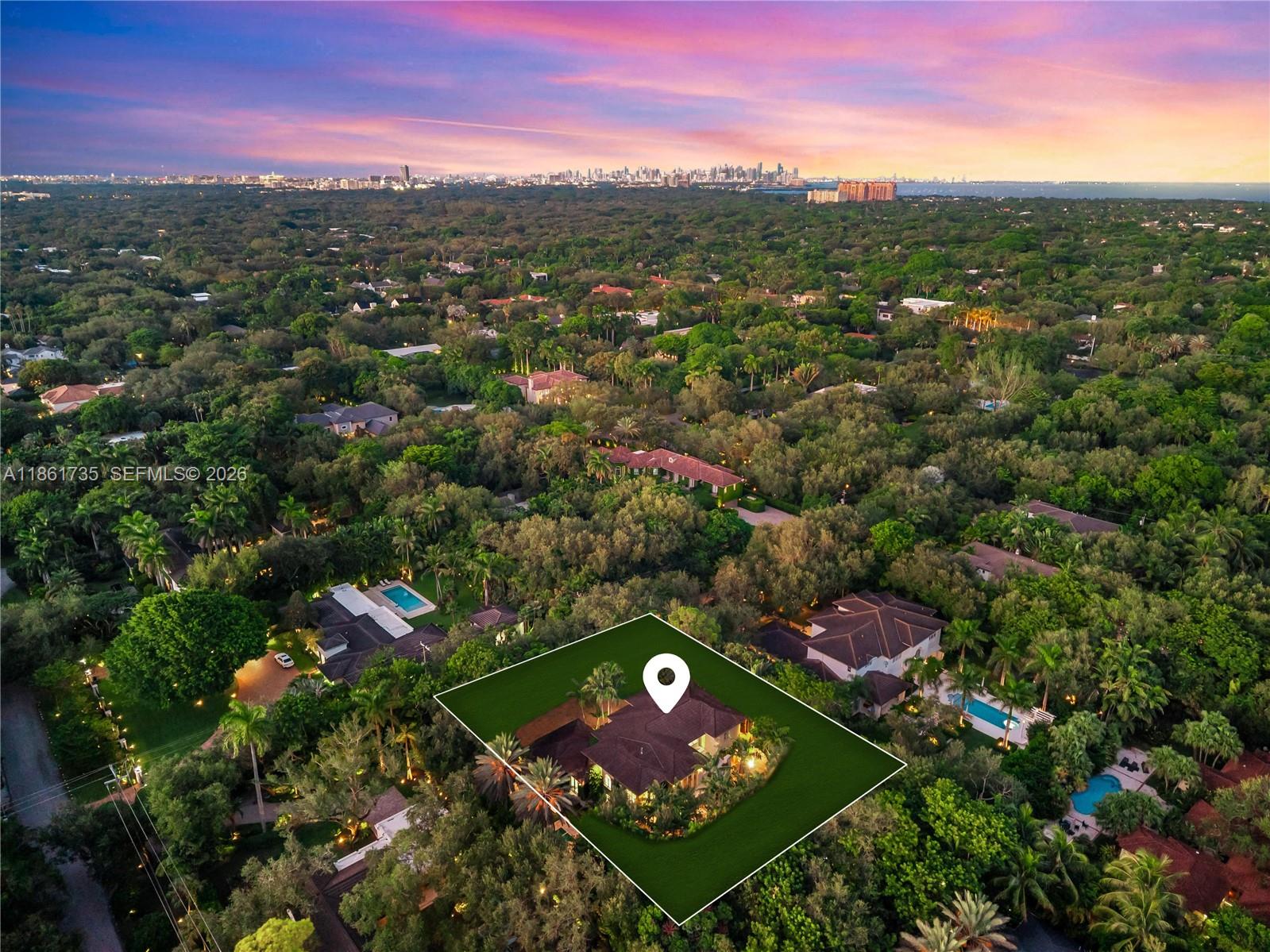 An aerial view shows a house with a highlighted property boundary amidst a lush forest — 5100 SW 86th St, Miami FL 33143, MIAMI, FL