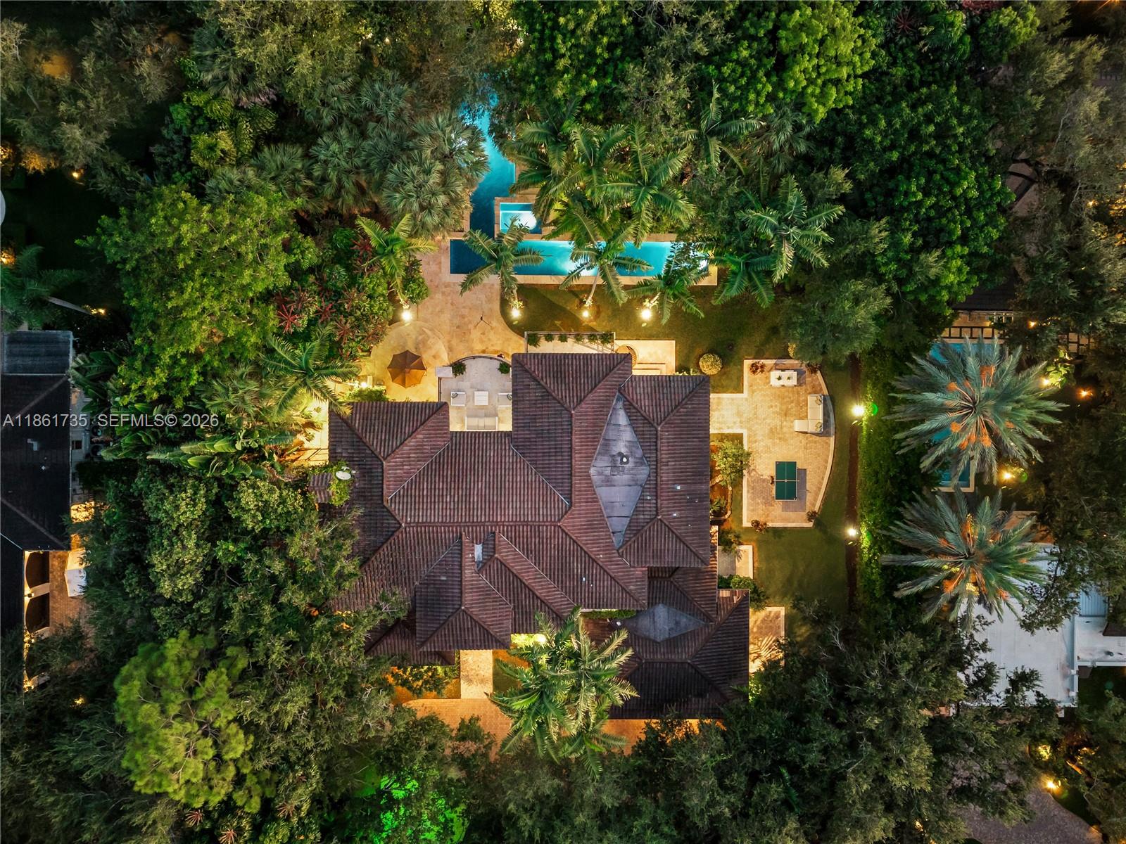 An aerial view shows a house with a tiled roof, swimming pool, and lush landscaping — 5100 SW 86th St, Miami FL 33143, MIAMI, FL