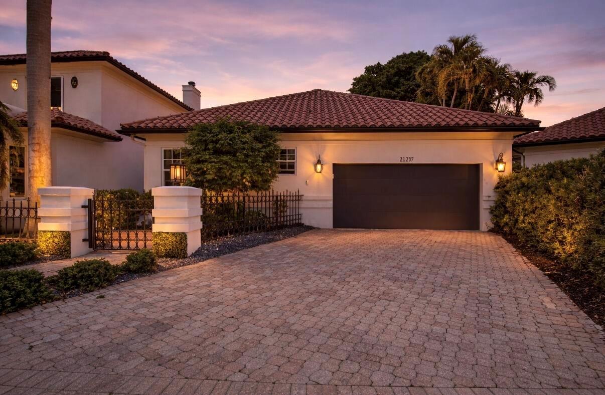 A single-story house with a tiled roof, a dark garage door, and a paved driveway — 21237 Harrow Court, Boca Raton FL 33433, BOCA RATON, FL