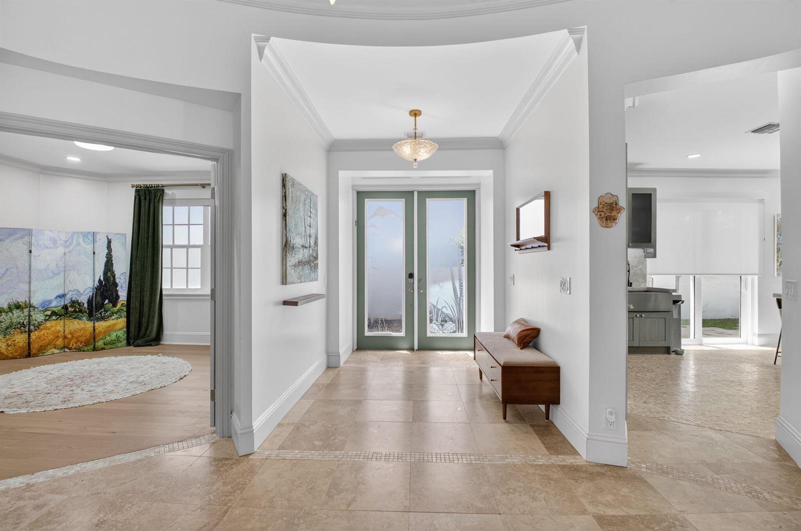 A bright entryway features light tile flooring, a wooden bench, and sage green double doors — 21237 Harrow Court, Boca Raton FL 33433, BOCA RATON, FL