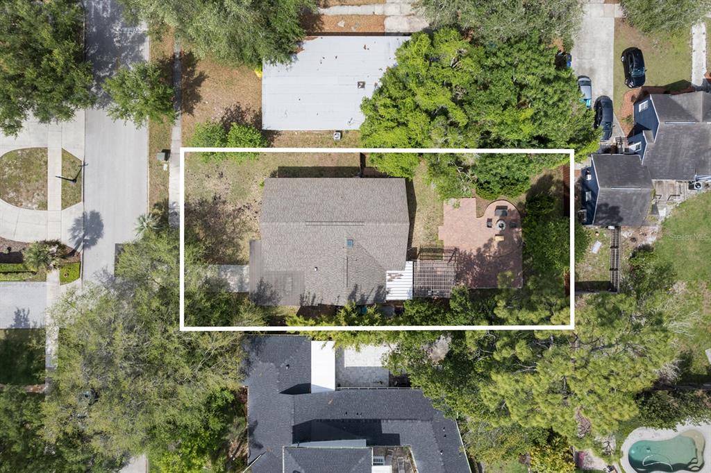 An aerial view shows a house with a shingled roof, patio, and surrounding trees — 1741 WESTCHESTER AVENUE, WINTER PARK, FL
