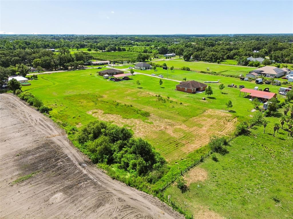 An aerial view shows a large, grassy residential lot with scattered houses and trees — 0 KILLEYMOON LANE, DOVER, FL