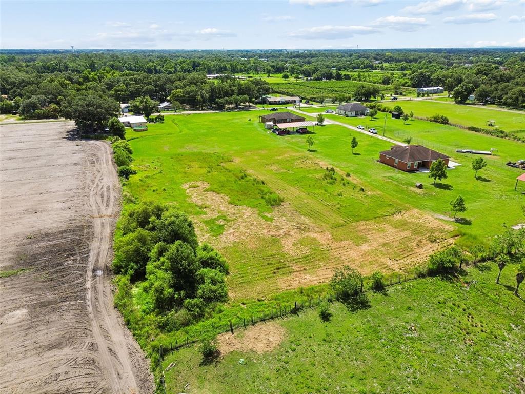 An aerial view shows a large, grassy lot with a house and detached carport — 0 KILLEYMOON LANE, DOVER, FL