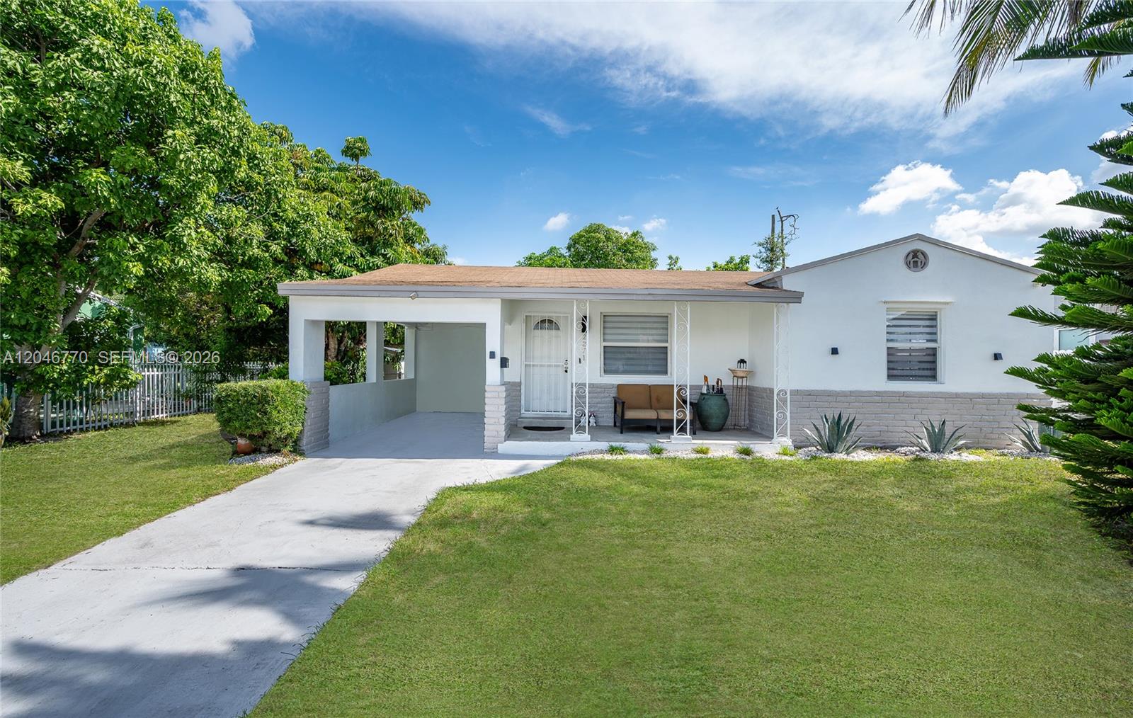 A single-story house with a white exterior, a carport, and a front lawn — 2371 NW 85th St, Miami FL 33147, MIAMI, FL