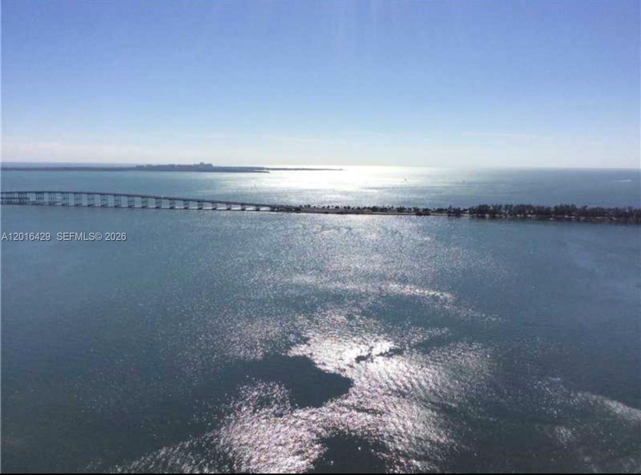 An aerial view shows a long bridge spanning across a large body of water — 1541 Brickell Ave # A3101, Miami FL 33129, MIAMI, FL