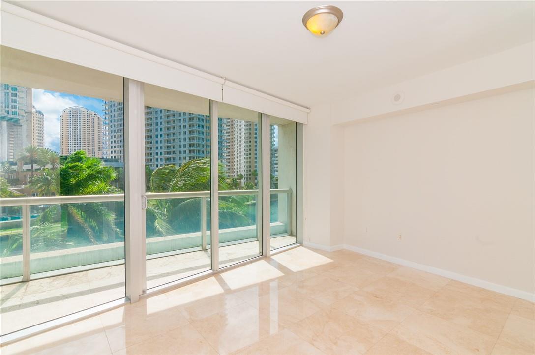 An empty room with light-colored tile floors, a ceiling light, and floor-to-ceiling windows — 465 Brickell Avenue # 419, Miami FL 33131, MIAMI, FL
