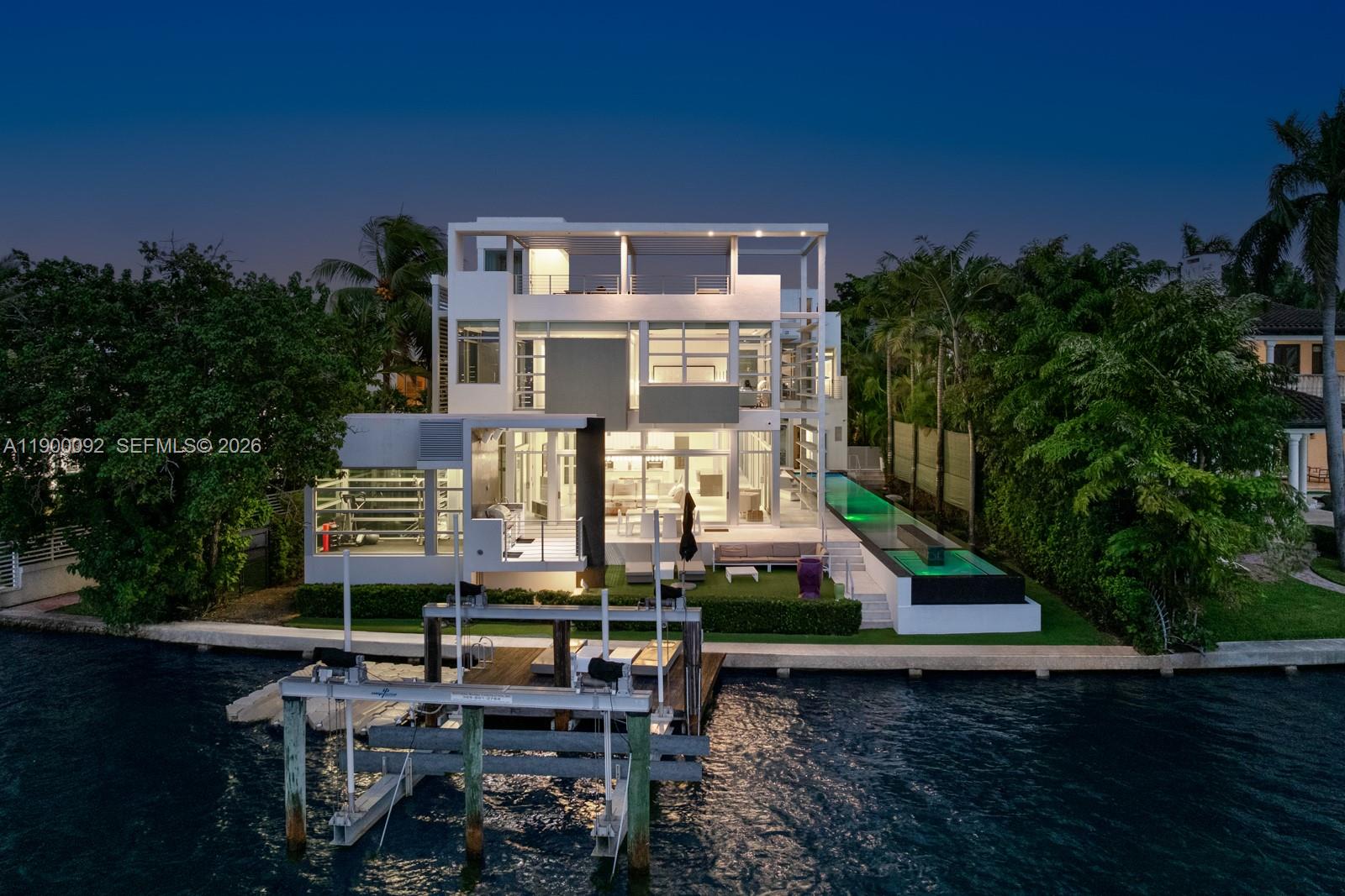An aerial view of a modern three-story waterfront home with a pool and boat lift — 440 S Hibiscus Dr, Miami Beach FL 33139, MIAMI BEACH, FL