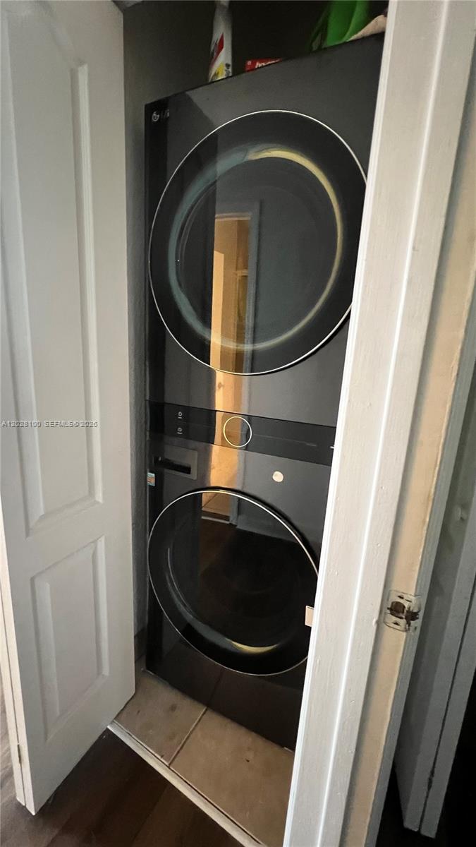 A stacked black washer and dryer unit is installed inside a small closet — 2620 Pierce St # A3, Hollywood FL 33020, HOLLYWOOD, FL
