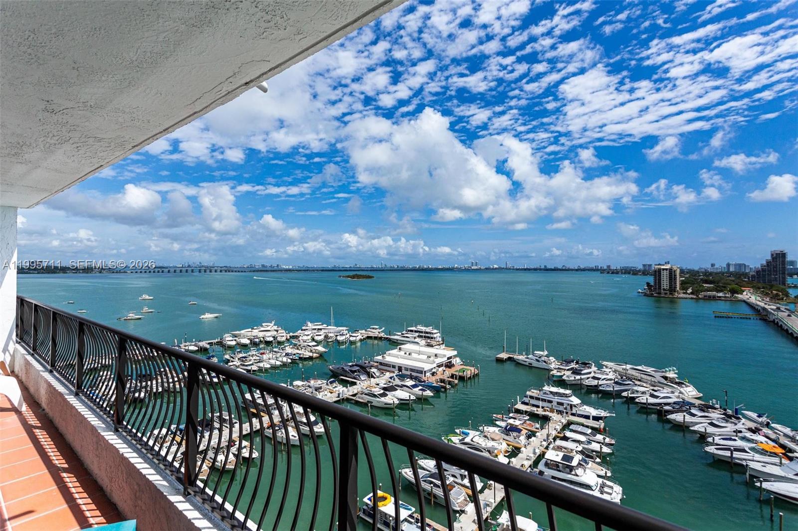 A high-angle view from a balcony overlooks a marina filled with boats on the water — 555 NE 15th St # 15B, Miami FL 33132, MIAMI, FL