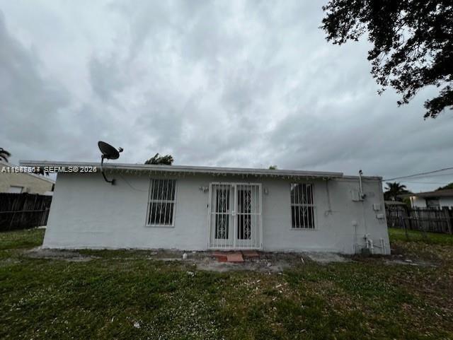 The exterior of a white, single-story house features a central double door with security grilles — 3811 SW 31st Ct, West Park FL 33023, WEST PARK, FL