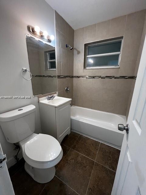 A bathroom features a white toilet, a small vanity, and a tiled tub-shower combination — 3811 SW 31st Ct, West Park FL 33023, WEST PARK, FL