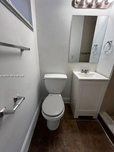 A small bathroom features a white toilet, a pedestal vanity with a sink, and tile flooring — 3811 SW 31st Ct, West Park FL 33023, WEST PARK, FL