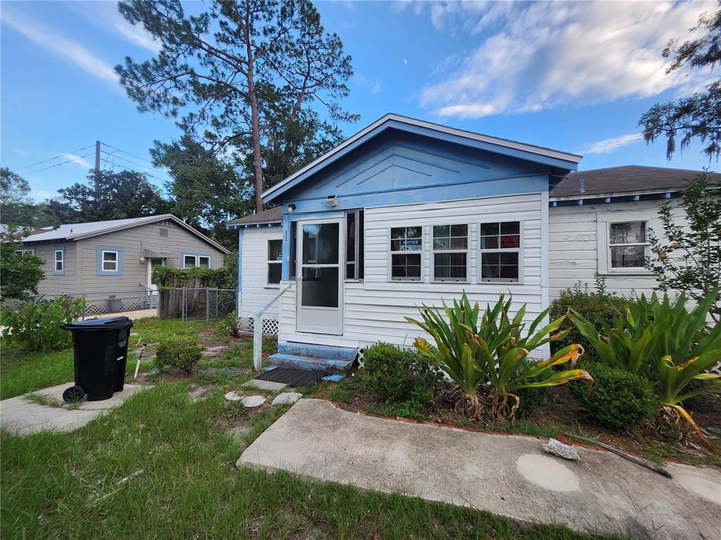 A single-story house with white siding, a blue gable, and a front entrance with stairs — 1427 SE 1ST AVENUE, GAINESVILLE, FL