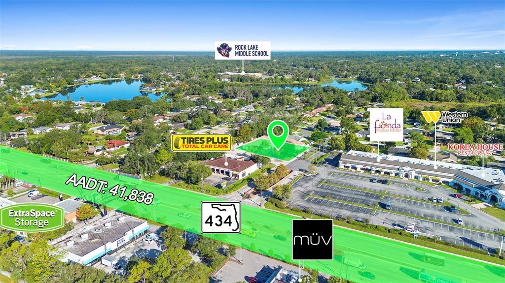 This aerial view shows a commercial property site highlighted in green along a busy road — 330 HARBOUR ISLE WAY UNIT 1090, LONGWOOD, FL