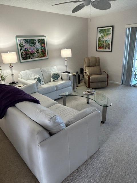 A living room features two white sofas, a recliner, a glass coffee table, and artwork — 1903 SW Palm City Road # 2, Stuart FL 34994, STUART, FL