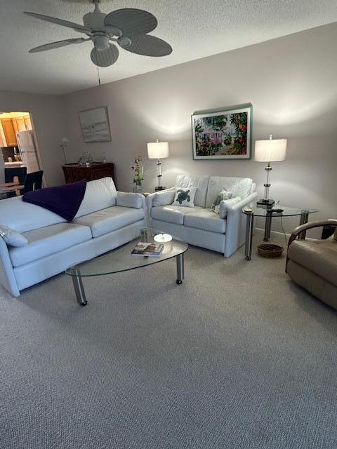 A living room features white leather sofas, a glass coffee table, and a ceiling fan — 1903 SW Palm City Road # 2, Stuart FL 34994, STUART, FL