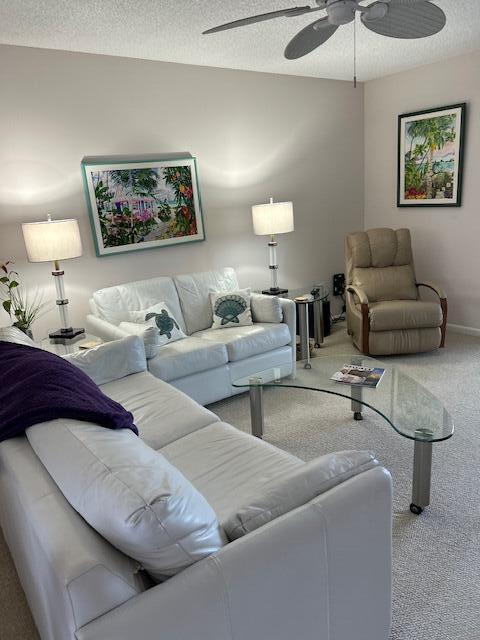 A living room features white leather sofas, a glass coffee table, and a beige recliner — 1903 SW Palm City Road # 2, Stuart FL 34994, STUART, FL