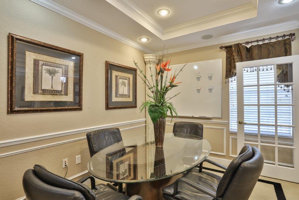 A home office features a glass-topped oval table, black leather chairs, and a white board — 437 APOLLO BEACH BOULEVARD UNIT F-4, APOLLO BEACH, FL